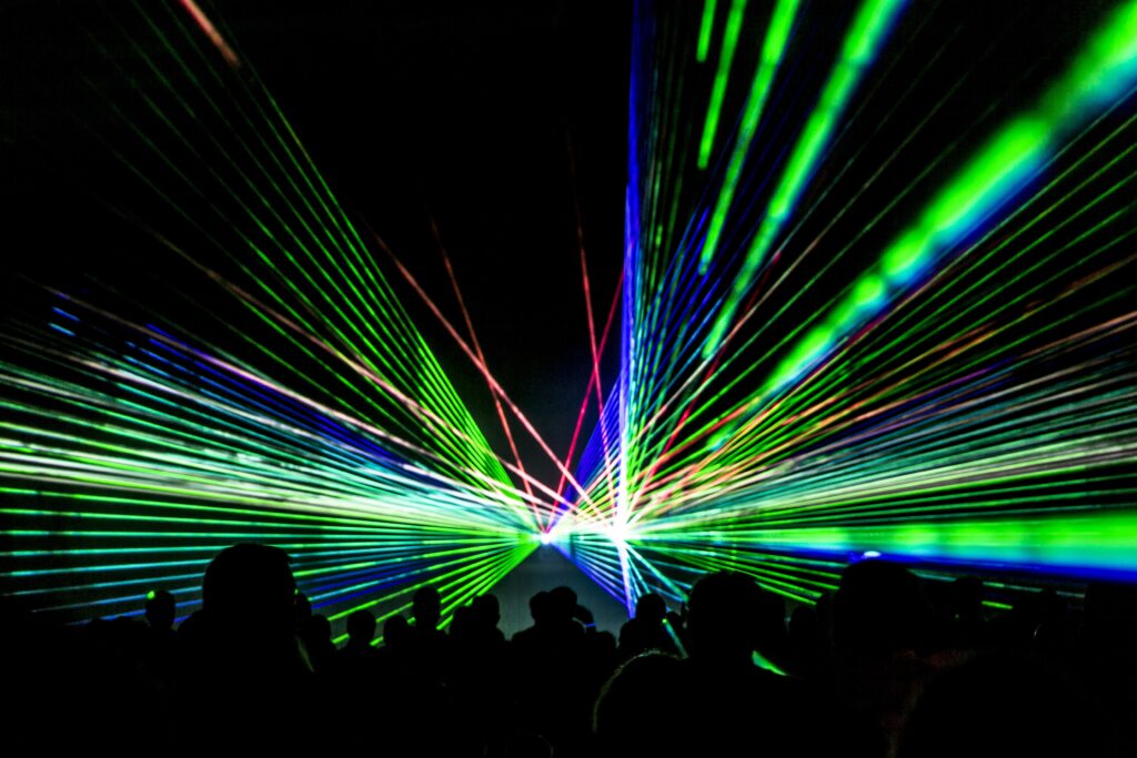 laser,show,rays,stream.,very,colorful,show,with,a,crowd