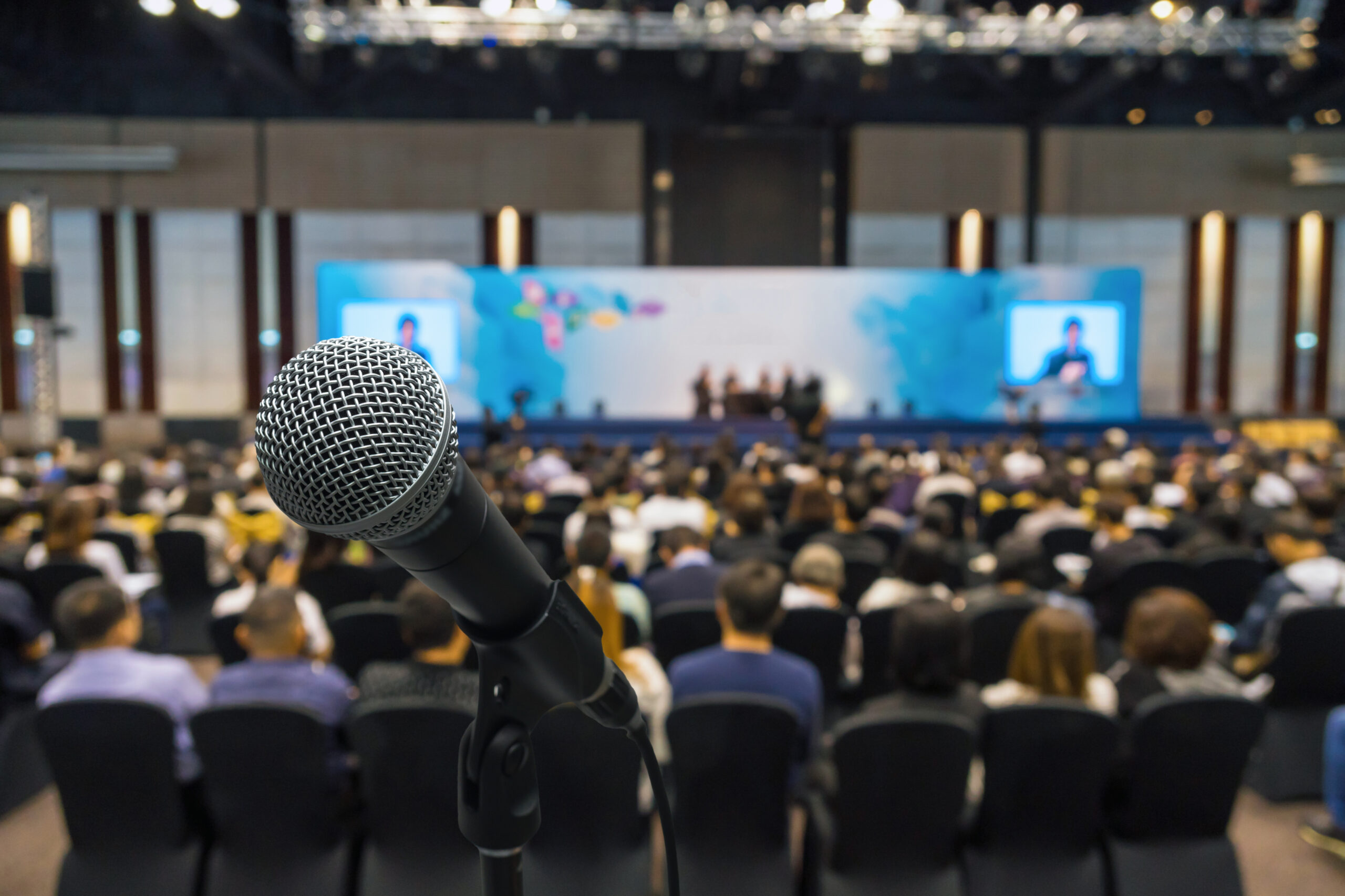 microphone,with,abstract,blurred,photo,of,conference,hall,or,meeting