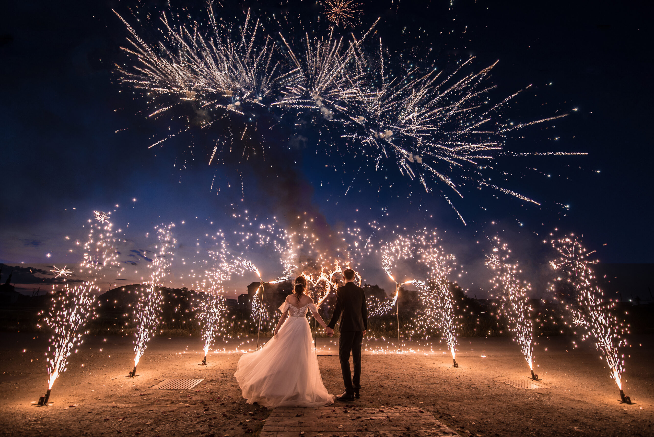 a,couple,in,wedding,dresses,on,the,background,of,fireworks